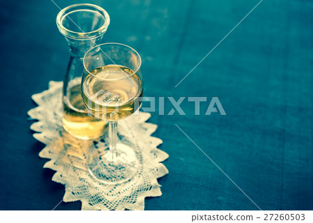 Glass of white wine in vintage decor Glass of white wine in vintage decor 27260503