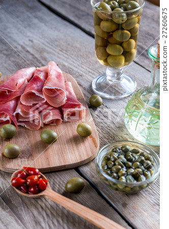 Jamon with capers and olives on the wooden board Jamon with capers and olives on the wooden board 27260675