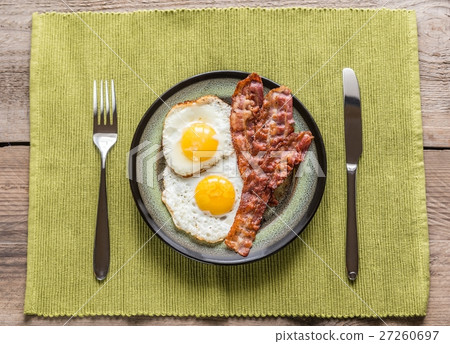 Portion of fried eggs with bacon 27260697