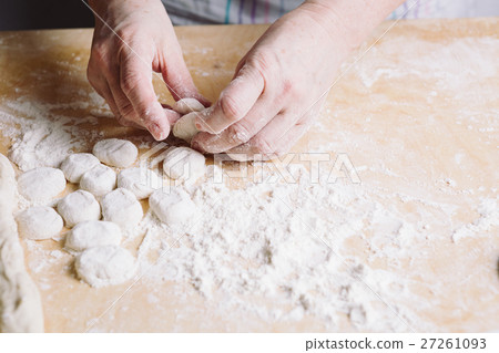 Two hands making dough for meat dumplings. Two hands making dough for meat dumplings. 27261093
