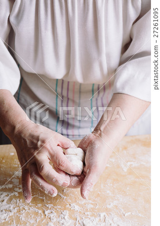 Two hands making meat dumplings. Two hands making meat dumplings. 27261095