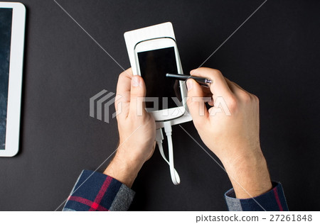 male hands holding a white cellphone  27261848
