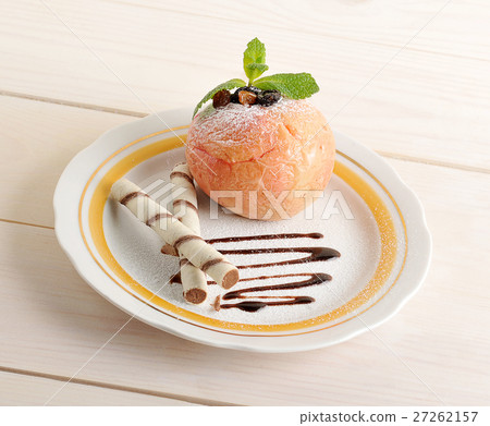 baked Apple with wafer rolls on a plate baked Apple with wafer rolls on a plate 27262157