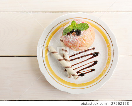 baked Apple with wafer rolls on a plate 27262158