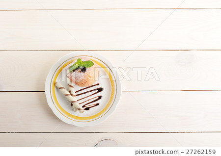 baked Apple with wafer rolls on a plate baked Apple with wafer rolls on a plate 27262159