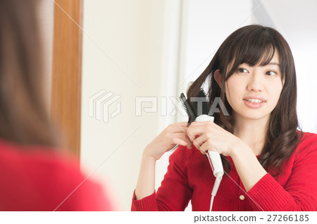 A woman wearing hair with a trowel A woman wearing hair with a trowel 27266185