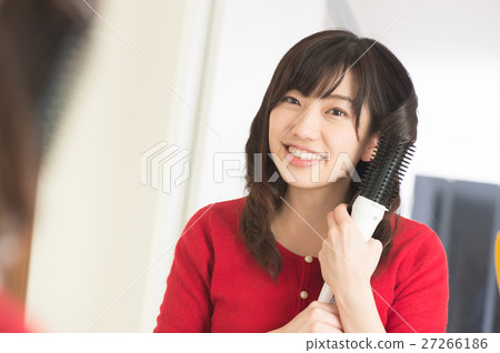 A woman wearing hair with a trowel A woman wearing hair with a trowel 27266186