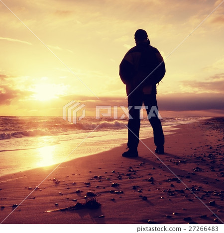 Man at evening sea. Hiker with hands in pocket 27266483