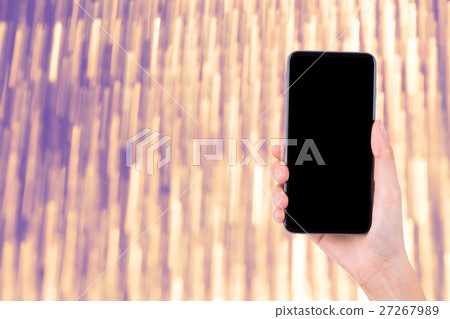 hand with mobile phone on bright background 27267989