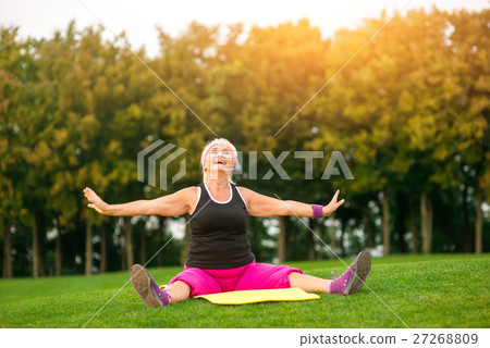 Senior lady on mat outdoors. Senior lady on mat outdoors. 27268809