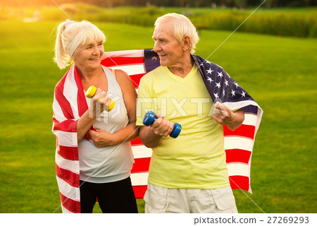 Senior couple holds dumbbells. Senior couple holds dumbbells. 27269293