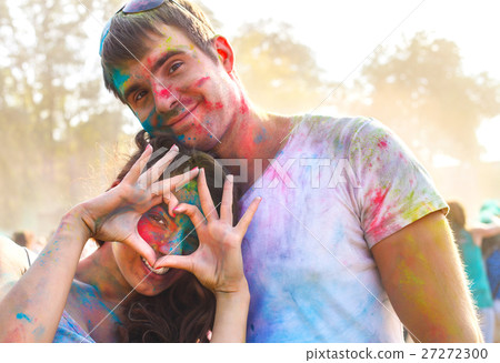 Happy couple in love on holi color festival Happy couple in love on holi color festival 27272300
