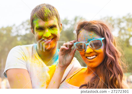 Portrait of happy couple on holi color festival Portrait of happy couple on holi color festival 27272301