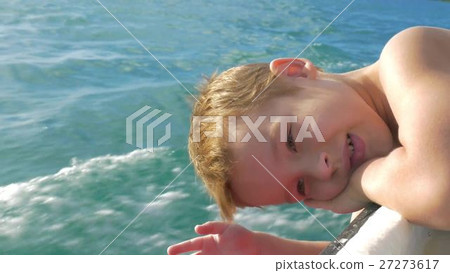 Child traveling by boat and trying to touch water Child traveling by boat and trying to touch water 27273617