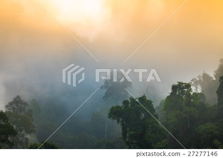 golden sky shine though the fog above the mountain 27277146