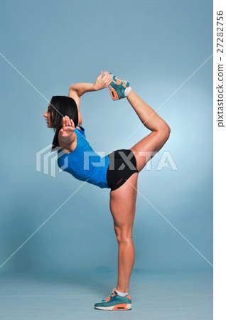 Athletic young woman doing stretching exercises Athletic young woman doing stretching exercises 27282756