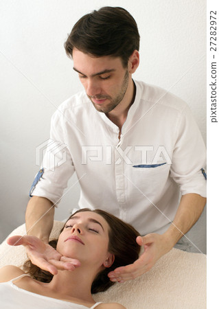 Master does massage to client on white background Master does massage to client on white background 27282972