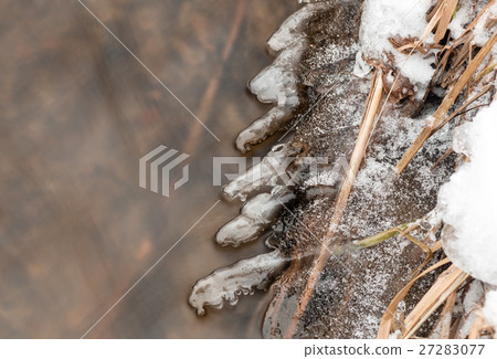 Thin layers of ice forming on the side of a Thin layers of ice forming on the side of a 27283077