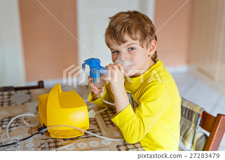 Cute kid boy making inhalation therapy by the mask 27283479