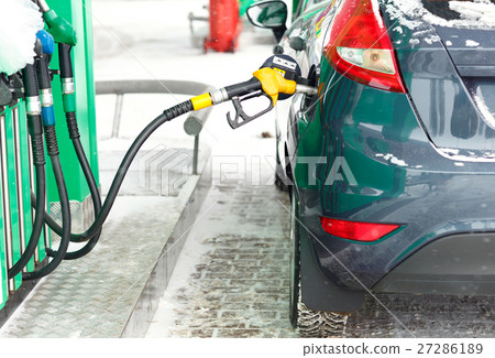 Car refueling on a petrol station in winter Car refueling on a petrol station in winter 27286189