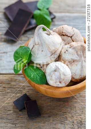 Chocolate meringue in bowl and dark chocolate. Chocolate meringue in bowl and dark chocolate. 27287316