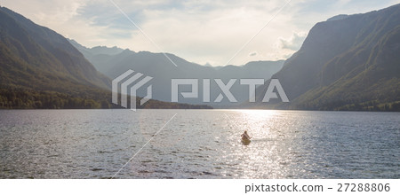 Family rowing in canoe boat on beautiful lake 27288806