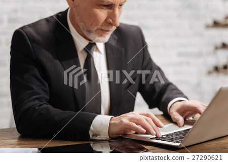 Mature executive writing a report 27290621