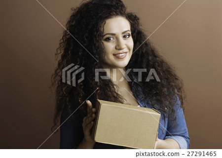 Delighted female holding box in both hands 27291465