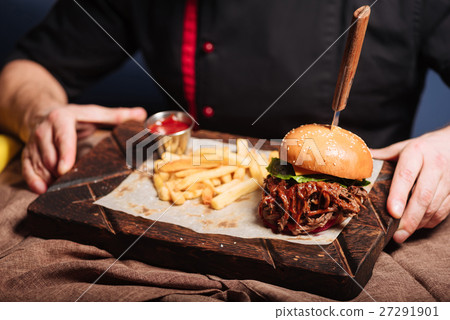 Happy man holding a tray with burger and French Happy man holding a tray with burger and French 27291901