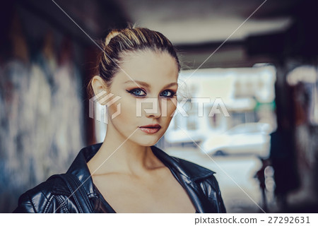 Beautiful girl with blue eyes close up on blurred Beautiful girl with blue eyes close up on blurred 27292631