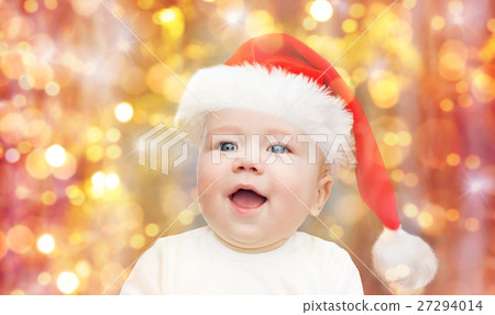 baby boy in christmas santa hat over blue lights baby boy in christmas santa hat over blue lights 27294014
