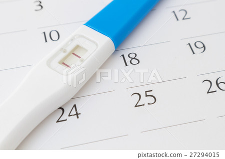 Pregnancy test on calendar background Pregnancy test on calendar background 27294015
