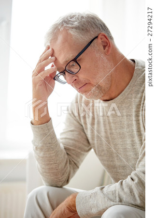 senior man suffering from headache at home 27294217