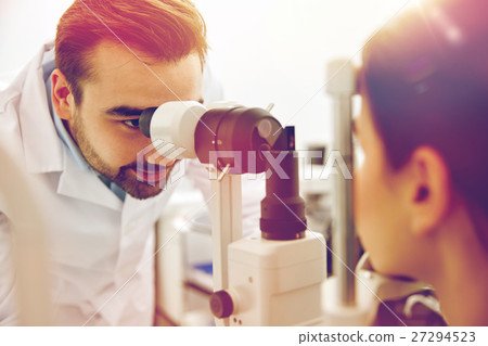 optician with tonometer and patient at eye clinic optician with tonometer and patient at eye clinic 27294523