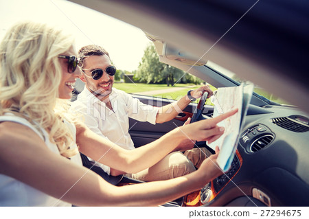 happy man and woman with map in cabriolet car happy man and woman with map in cabriolet car 27294675