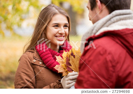 happy couple with maple leaves in autumn park happy couple with maple leaves in autumn park 27294698