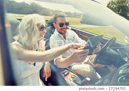 happy couple with tablet pc in cabriolet car 27294701