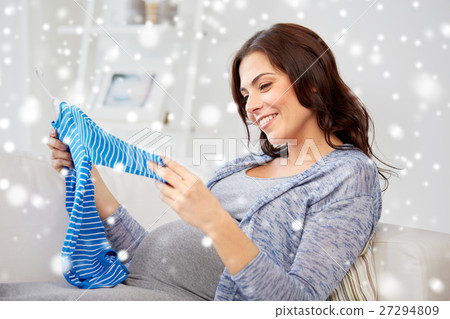 happy woman holding baby boys bodysuit at home happy woman holding baby boys bodysuit at home 27294809