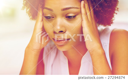 close up of african young woman touching her head close up of african young woman touching her head 27294874