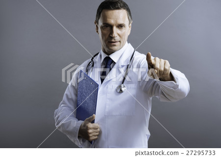 Handsome doctor pointing with his finger 27295733