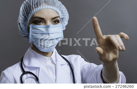 Close up of pretty woman wearing medical face mask 27296260