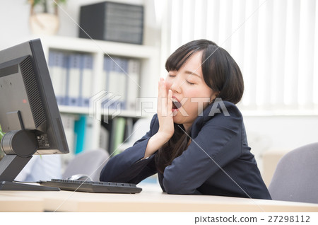 A woman tired at the office A woman tired at the office 27298112