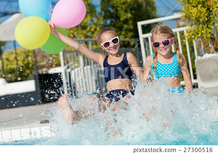 Two happy children playing on the swimming pool at the day time. 27300516