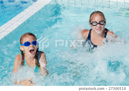 Two happy children playing on the swimming pool at the day time. 27300518