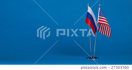 Two flags and hand on a blue background, Two flags and hand on a blue background, 27303560
