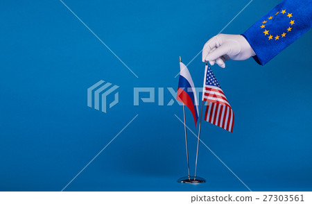 Two flags and hand on a blue background, Two flags and hand on a blue background, 27303561