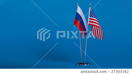 Two flags and hand on a blue background, Two flags and hand on a blue background, 27303562