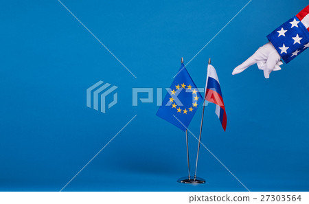 Two flags and hand on a blue background, 27303564