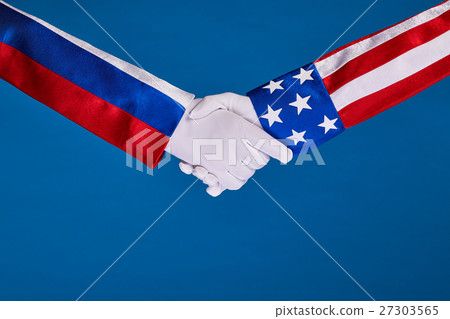 Two flags and hand on a blue background, Two flags and hand on a blue background, 27303565