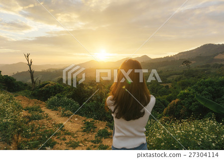 woman hiker taking photo at mountain 27304114